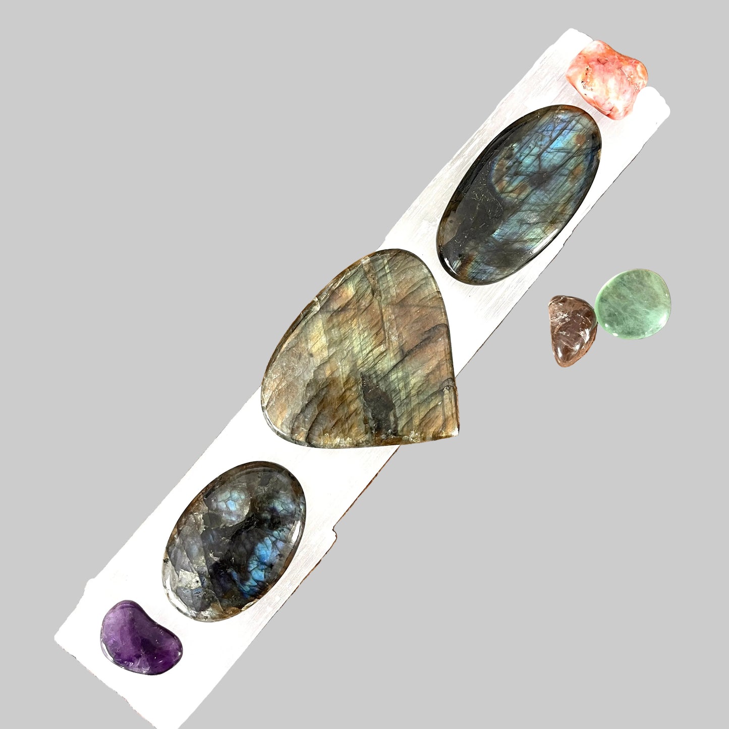 Set of polished stones on a white card with a wooden background