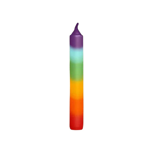 Colorful candle with a gradient from purple to red on a beige background