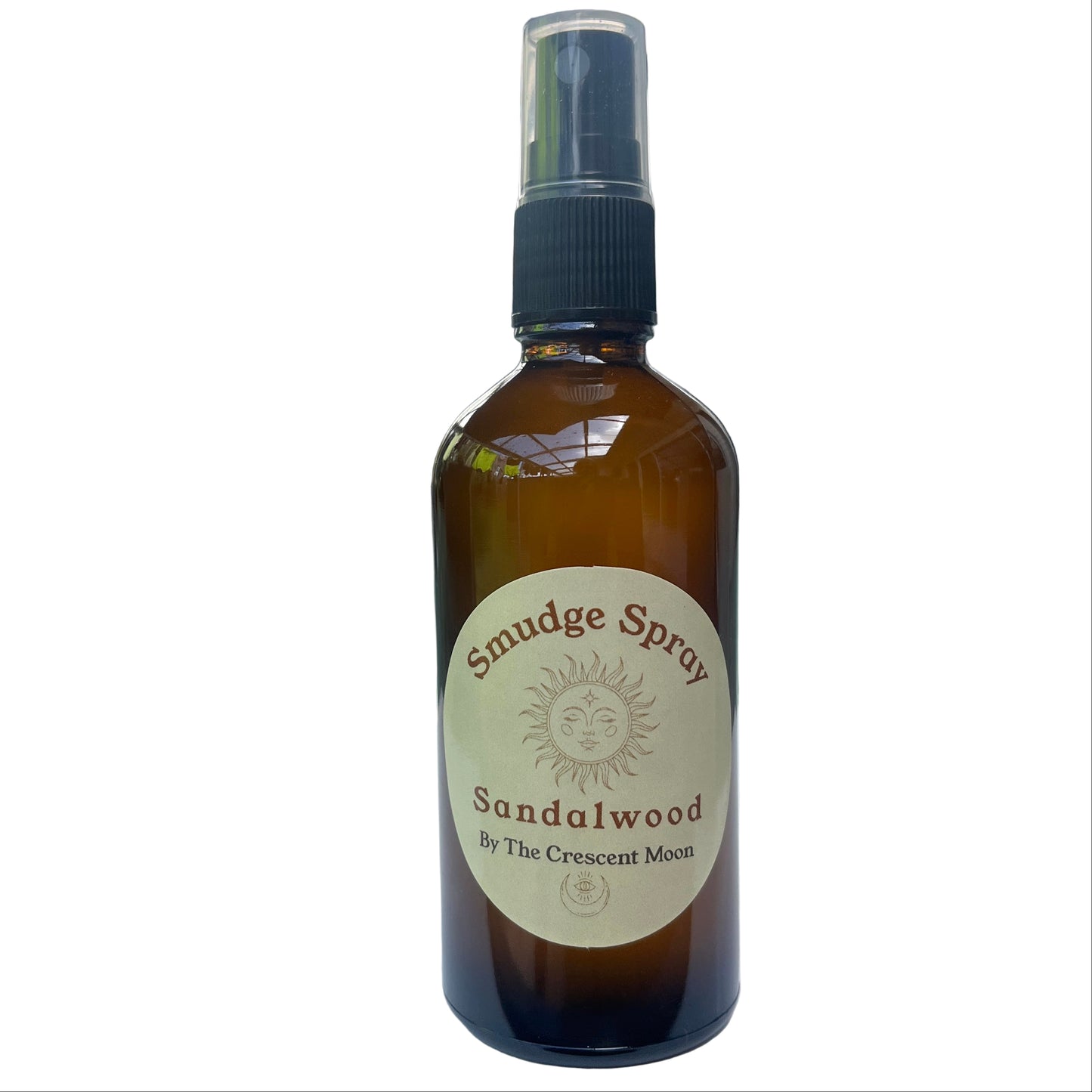 Brown spray bottle labeled 'Smudge Spray Sandalwood' by 'The Crescent Moon'