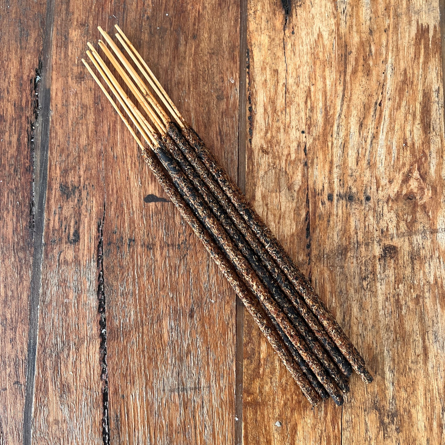 Incense sticks on a wooden surface