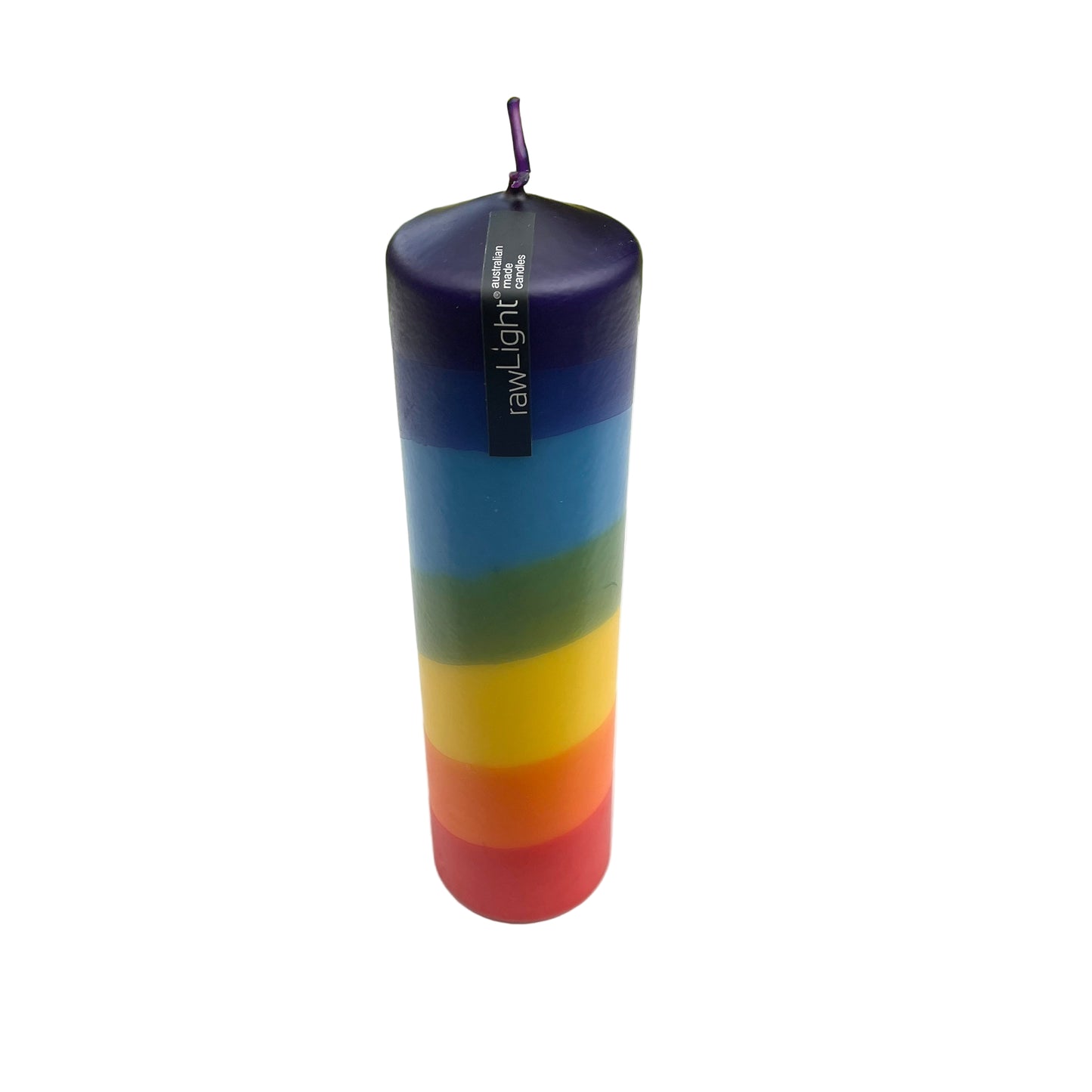 Colorful striped candle with 'rawlight' branding on a white surface with a blurred natural background.