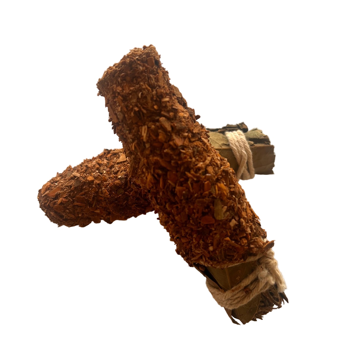 Two smudge sticks tied together with twine on a white surface