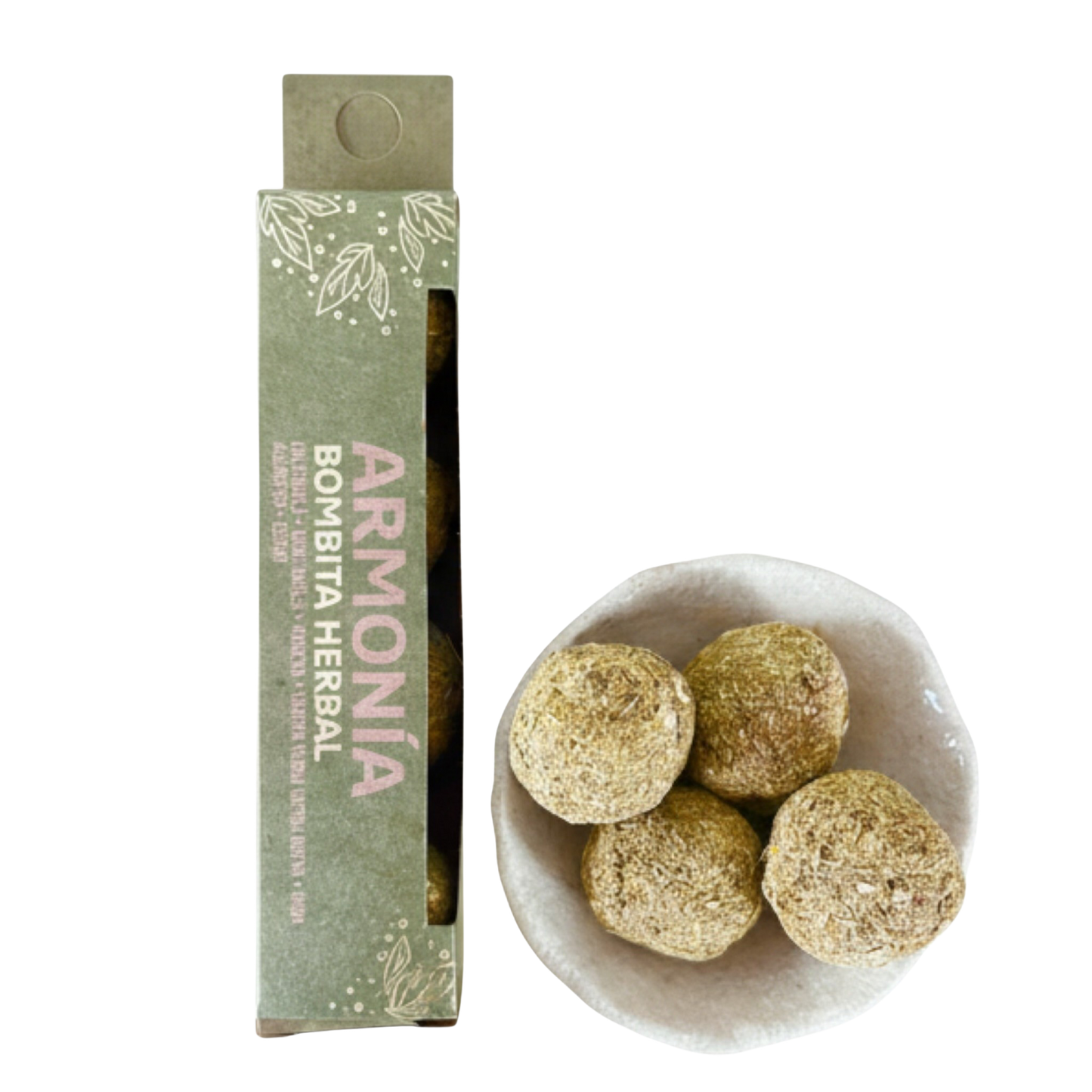 Herbal balls in a bowl with packaging labeled 'Armonía Bombita Herbal' on a white background