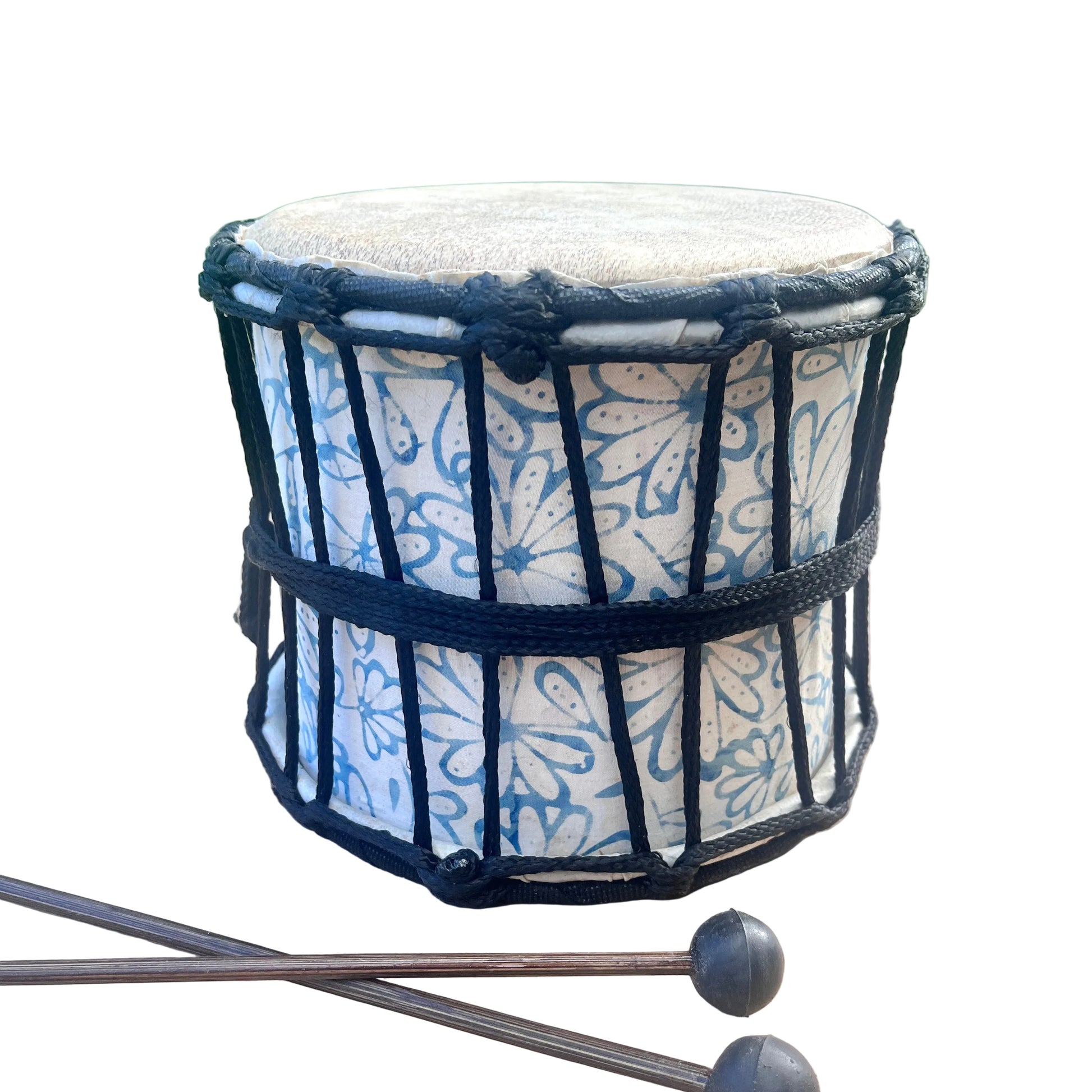 A small hand drum with a blue and white floral patterned body, black rope tensioning, and a light beige drum head