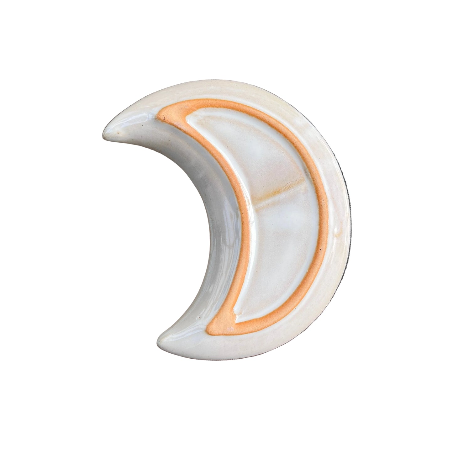 A crescent moon-shaped ceramic dish from underside