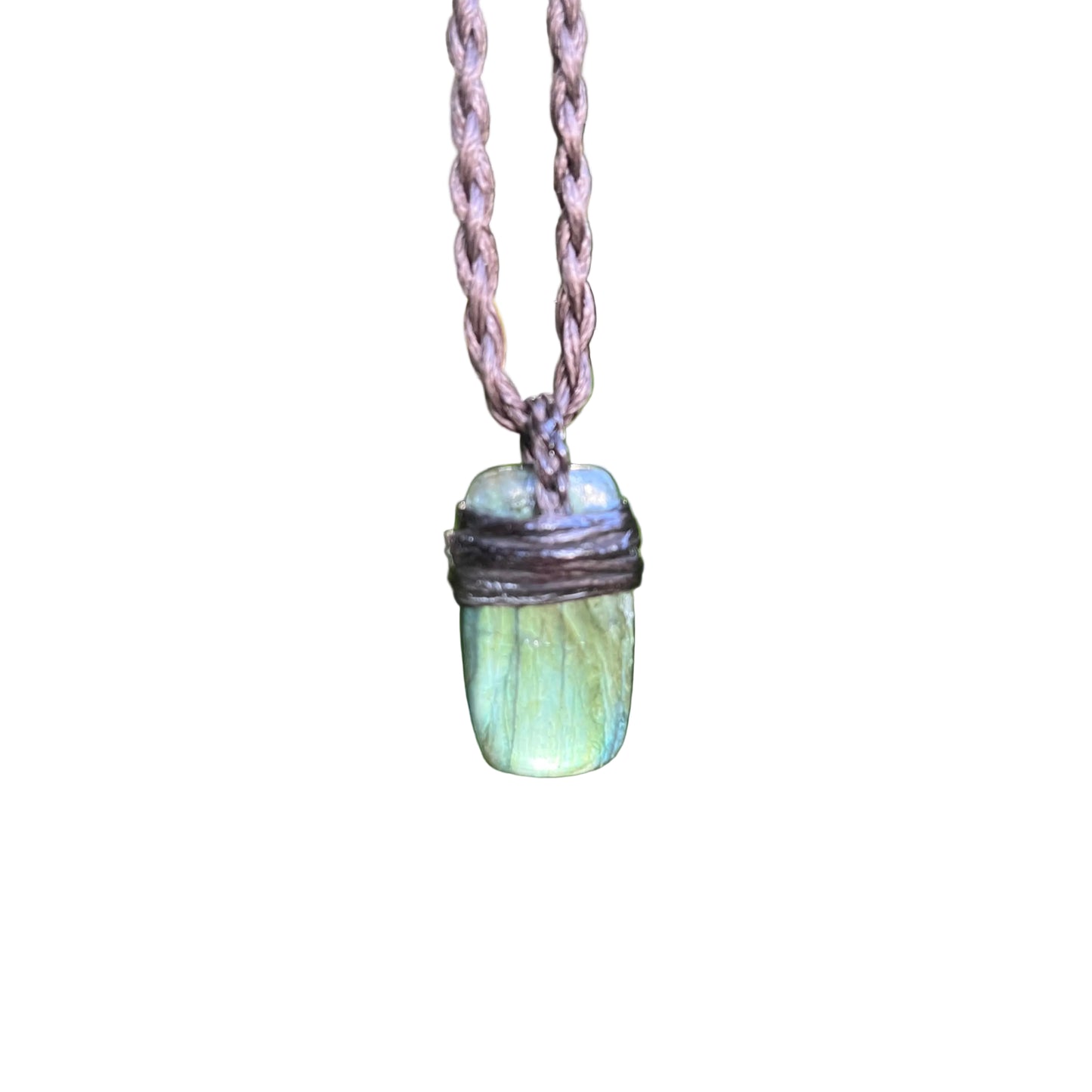 A green iridescent stone pendant necklace with a dark wrapped top and a braided brown cord 