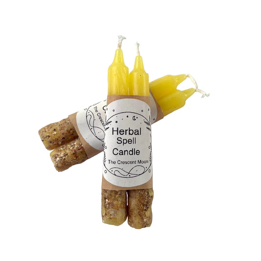 yellow spell candles with herbs