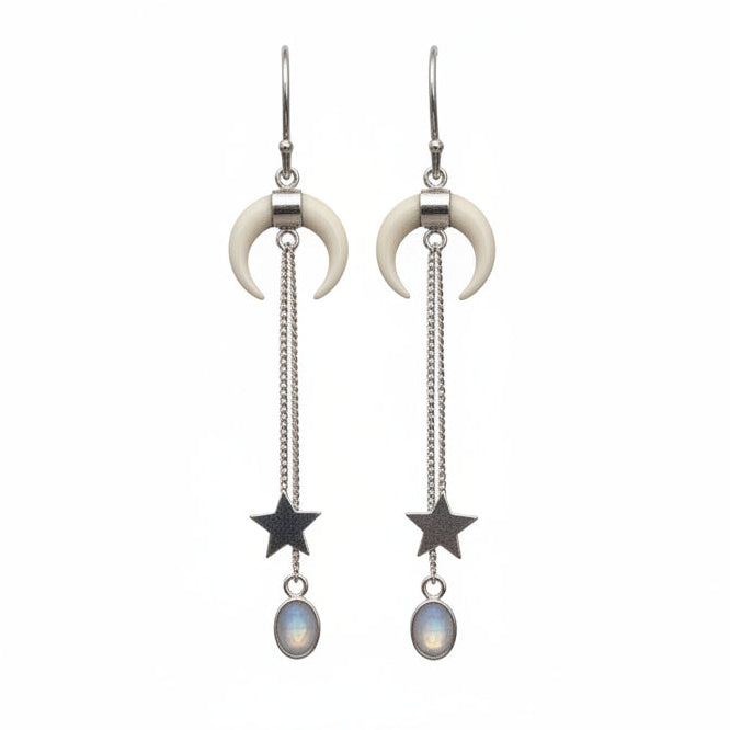 Pair of earrings with crescent moon and star designs on a white background