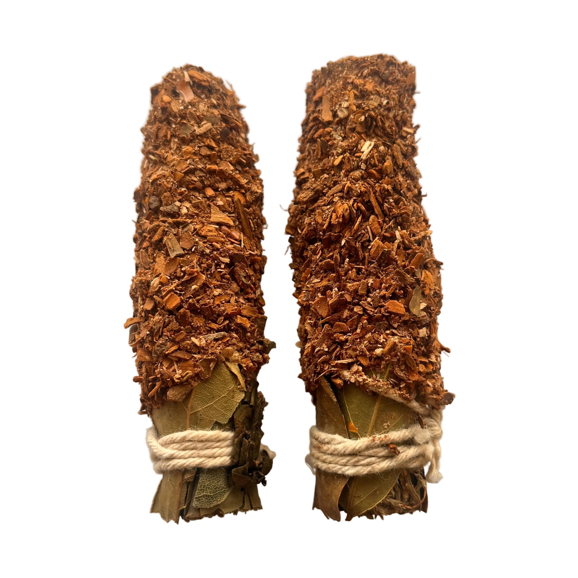 Two bundles of dried herbs tied with twine on a white background
