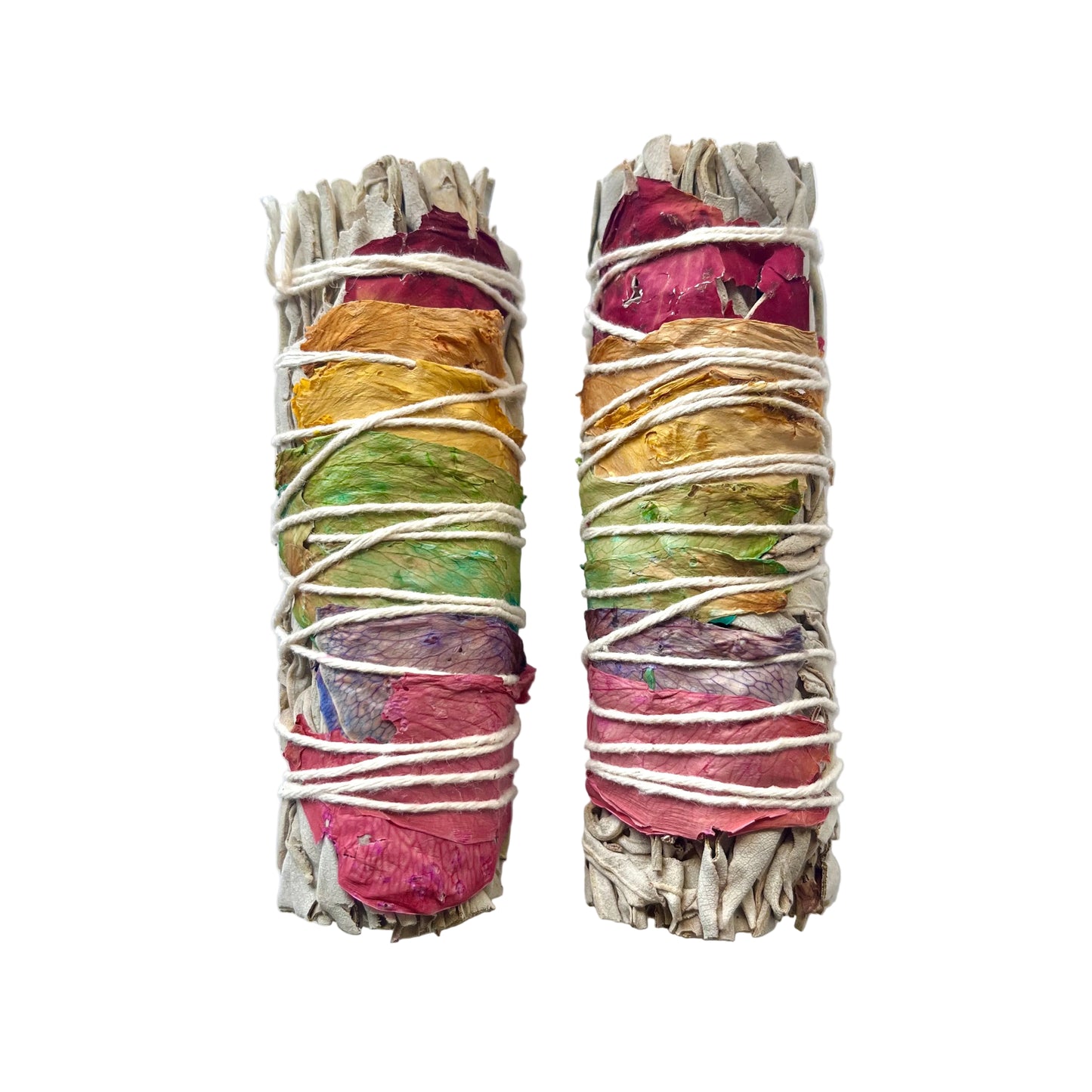 Two dried flower and herb smudge sticks wrapped in white string, displayed on a white textured background.