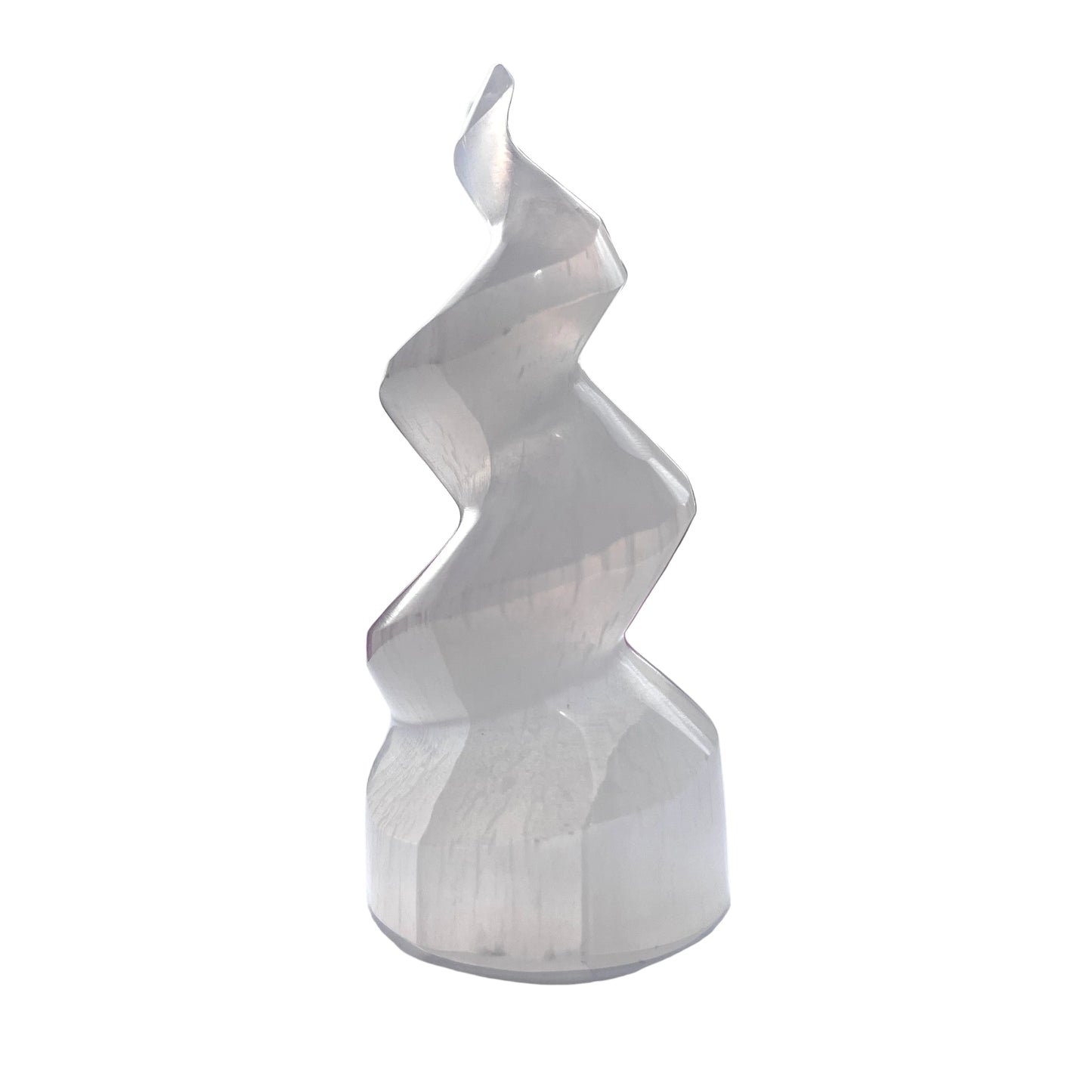 White spiral selenite tower on a white surface with blurred background