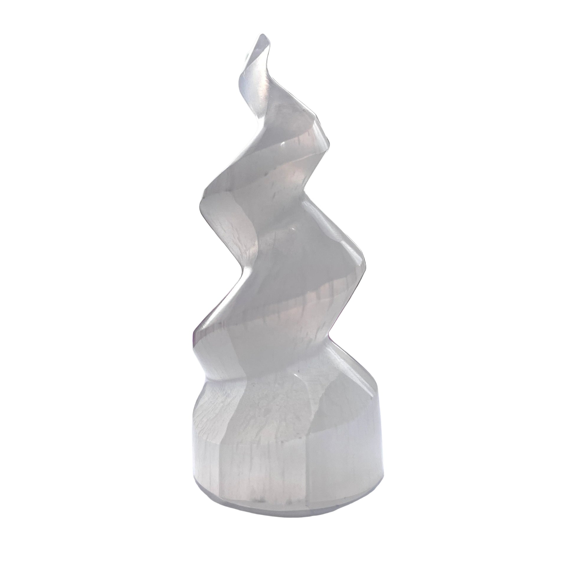 White spiral selenite tower on a white surface with blurred background