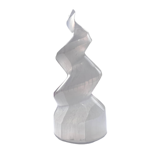 White spiral selenite tower on a white surface with blurred background
