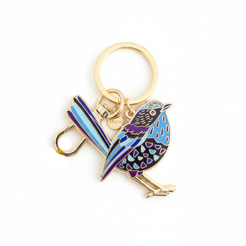 Bird-shaped keychain with gold ring on a white background