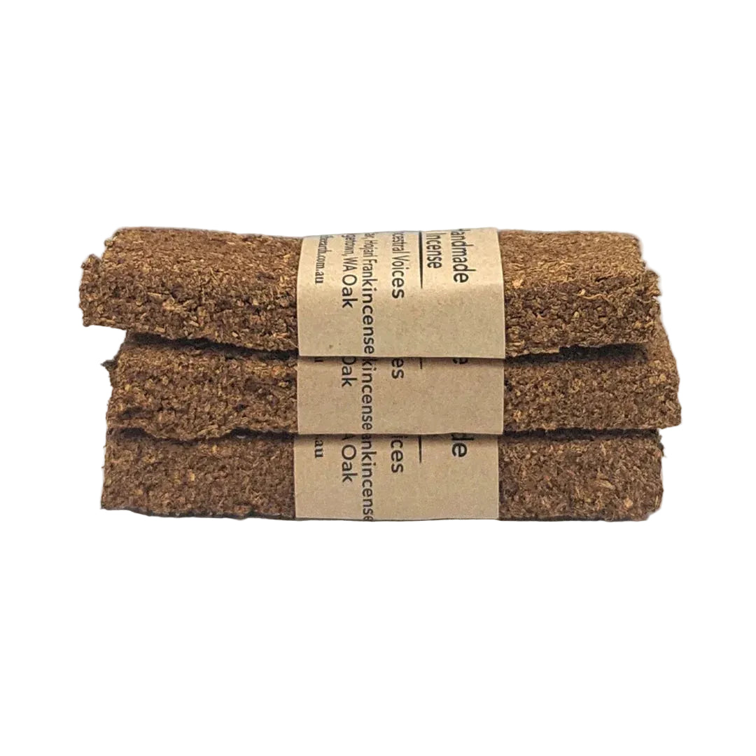 Three stacked incense sticks with a brown label on a white background