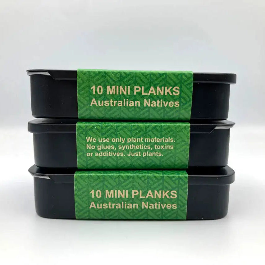 Three black containers of Tribe earth australian native incense samples with green labels on a white background
