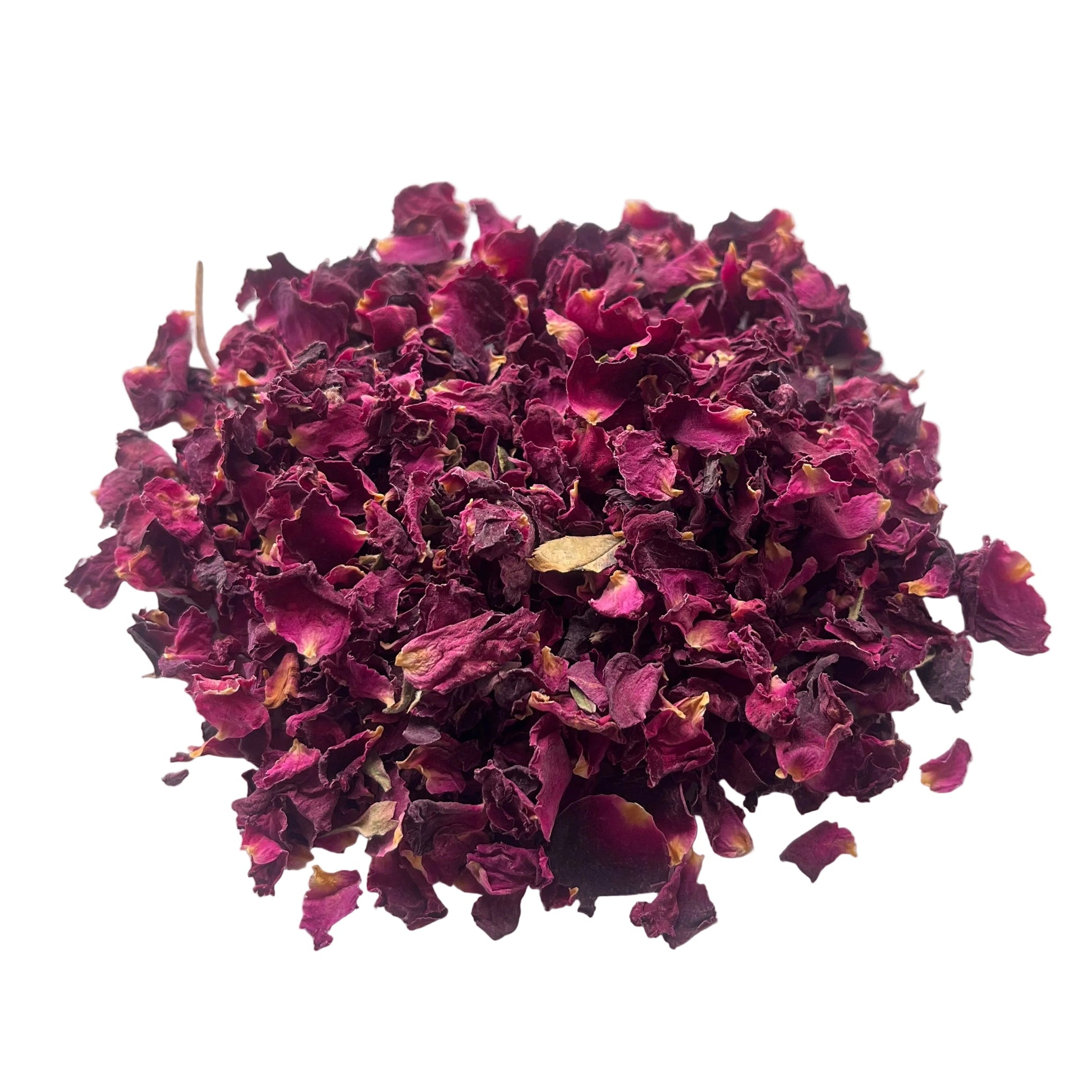 A small pile of dried rose petals or loose flower buds in deep magenta and burgundy tones, placed on a white surface.