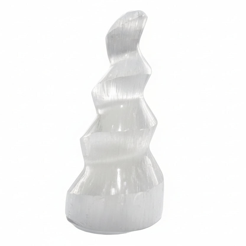 White stone sculpture on a white surface with a blurred background