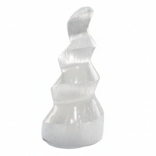 White stone sculpture on a white surface with a blurred background