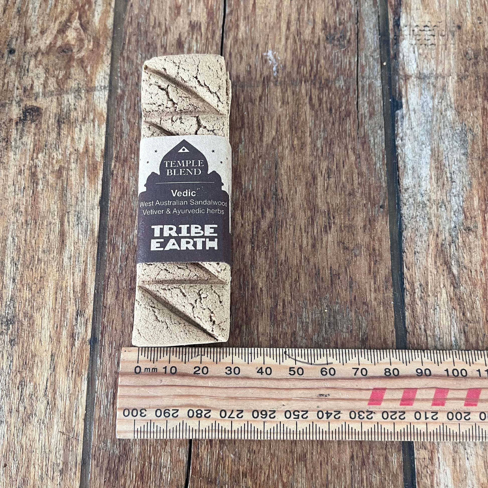 Tribe Earth product on a wooden surface with a ruler for scale