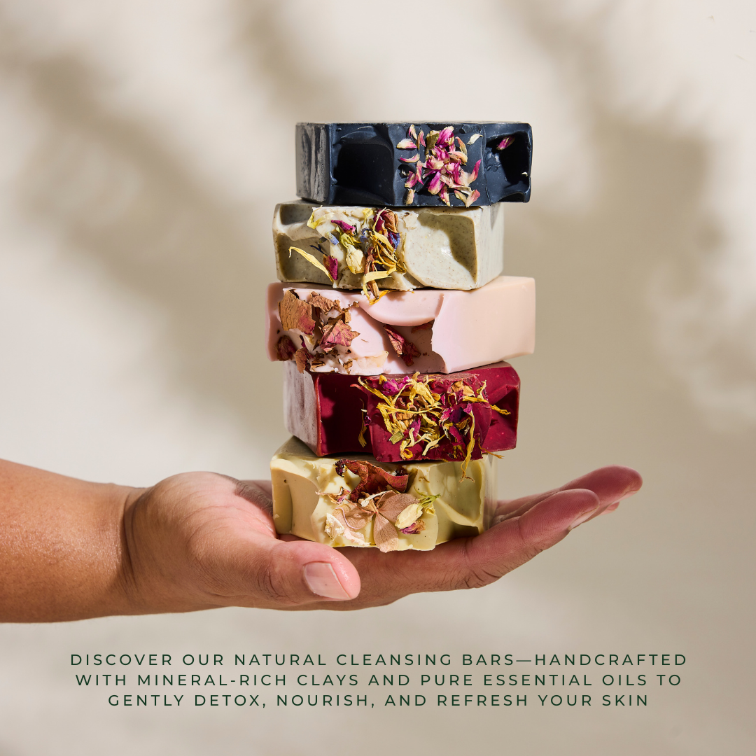 Stack of colorful natural cleansing bars held in a hand with a blurred background