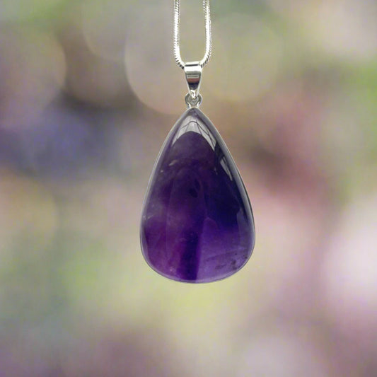 Purple teardrop pendant on a silver chain 