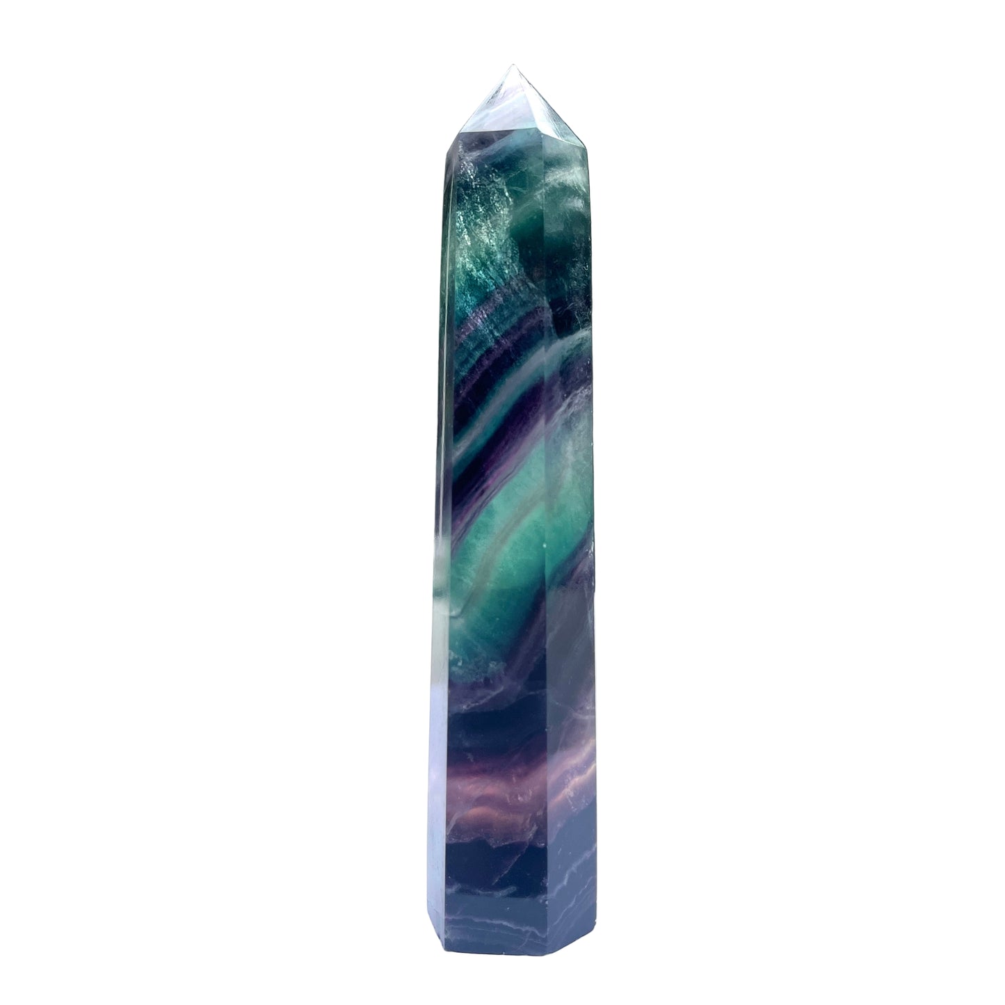 Multicolored fluorite crystal tower on a white surface 