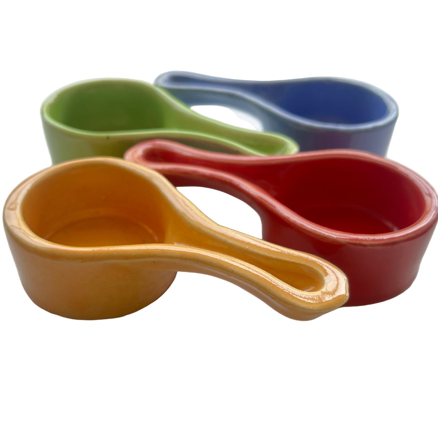 Set of colorful ceramic charcoal burners on a white surface