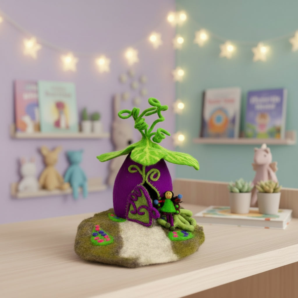 Felt fairy house with a purple door and green leaves on a white background