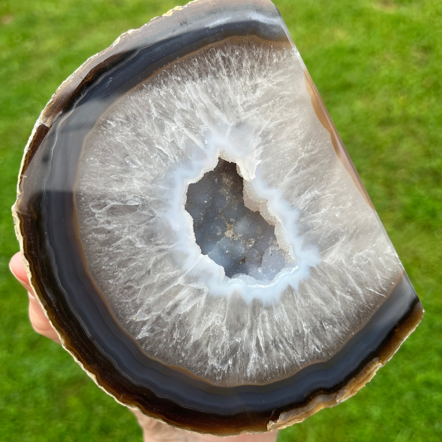 Close-up of an agate stone with a green grass background