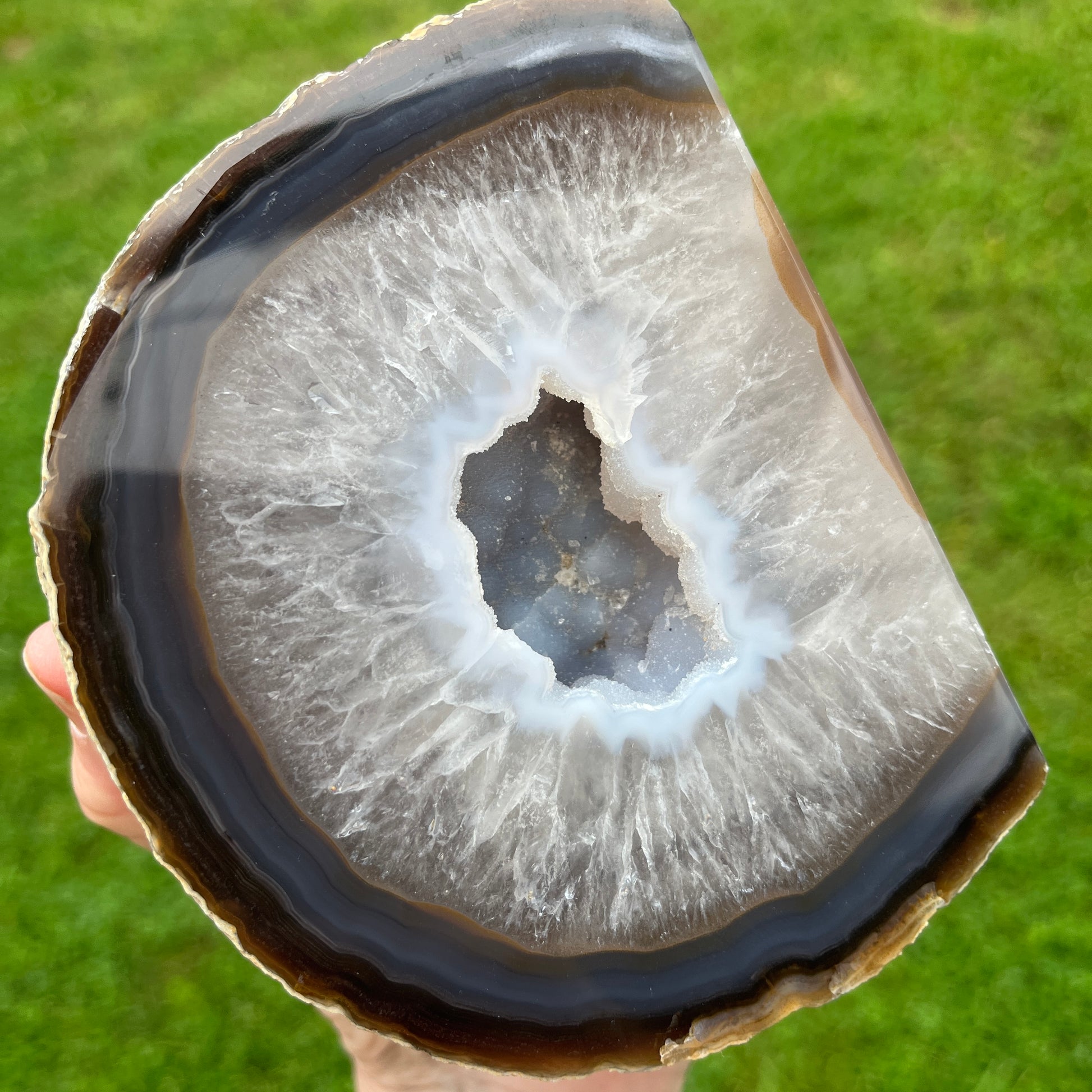 Close-up of an agate stone with a green grass background