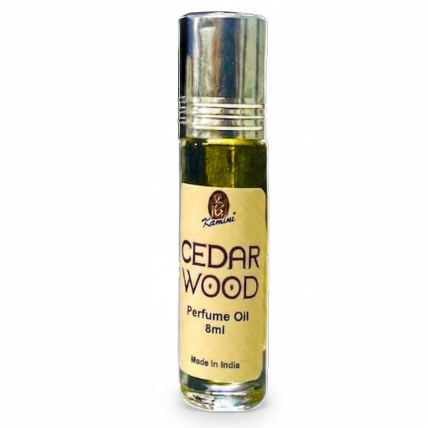 small roll-on perfume oil bottle labeled Cedar Wood Perfume Oil 8ml, arranged in a row against a plain white background.