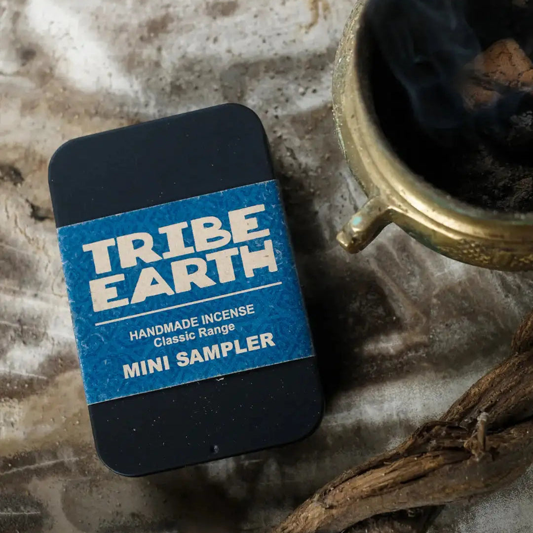 Tribe Earth incense mini sampler on a stone surface with an incense holder and sticks.