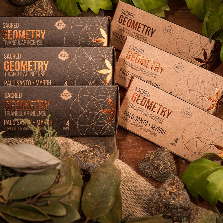 Sacred Geometry incense packaging on a wooden surface with plants