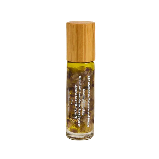 Roll-on bottle of essential oil perfume with bamboo cap on a neutral background