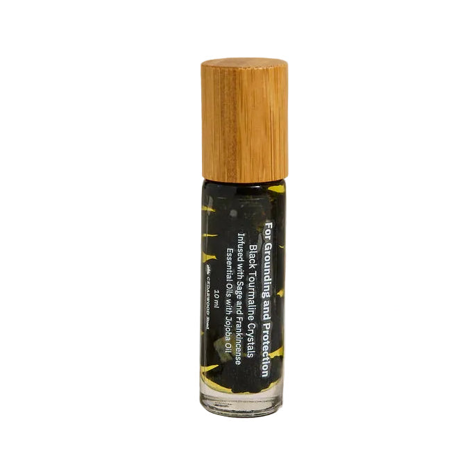 Crystal roller with black tourmaline for protection with wooden cap on a beige background