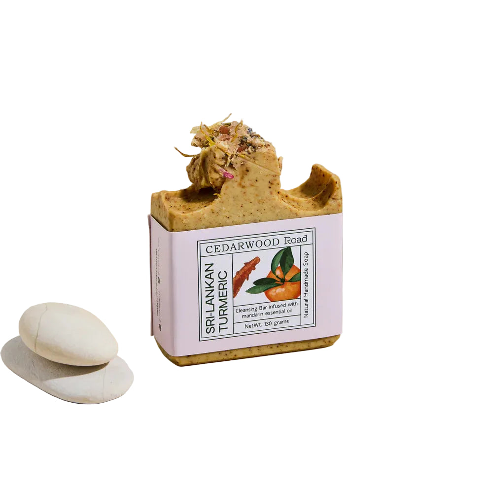 Bar of soap with a decorative top on a Cedarwood Road packaging box against a beige background
