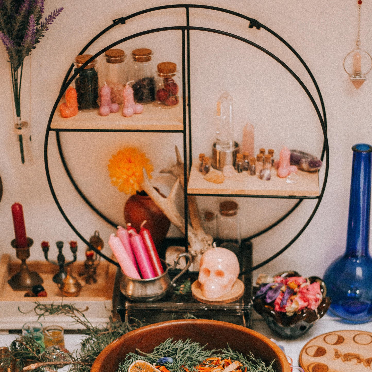 Witchcraft altar with various items including a wooden bowl, candles, and crystals.