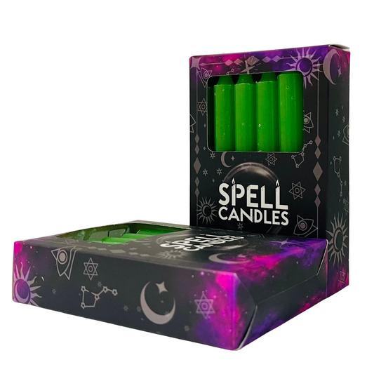 Box of green spell candles with mystical symbols on a white background