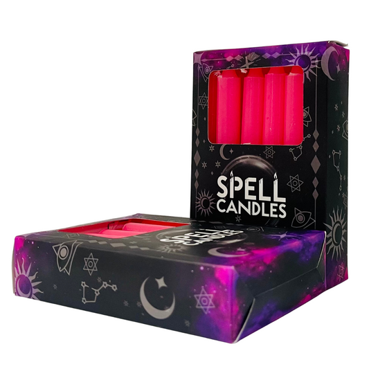 Box of pink spell candles with astrological symbols on a white background
